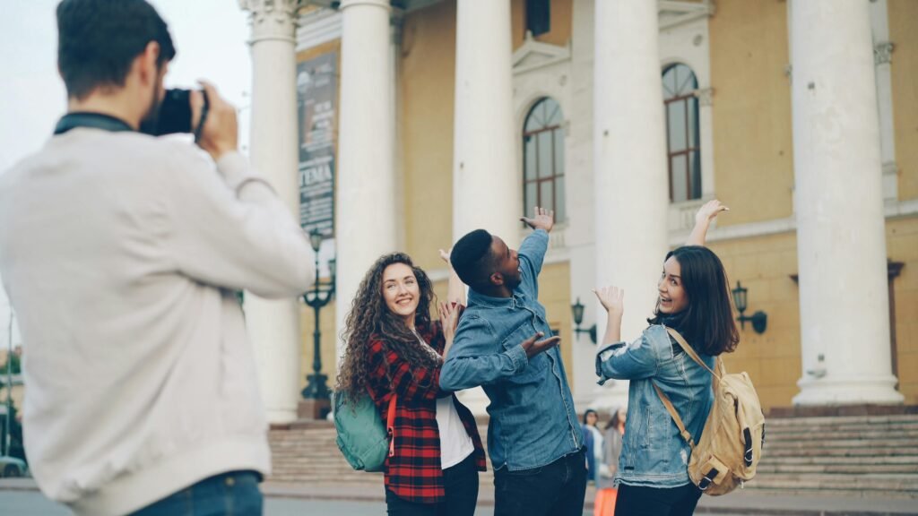 Group of friends posing outdoors in front of historic building with columns.